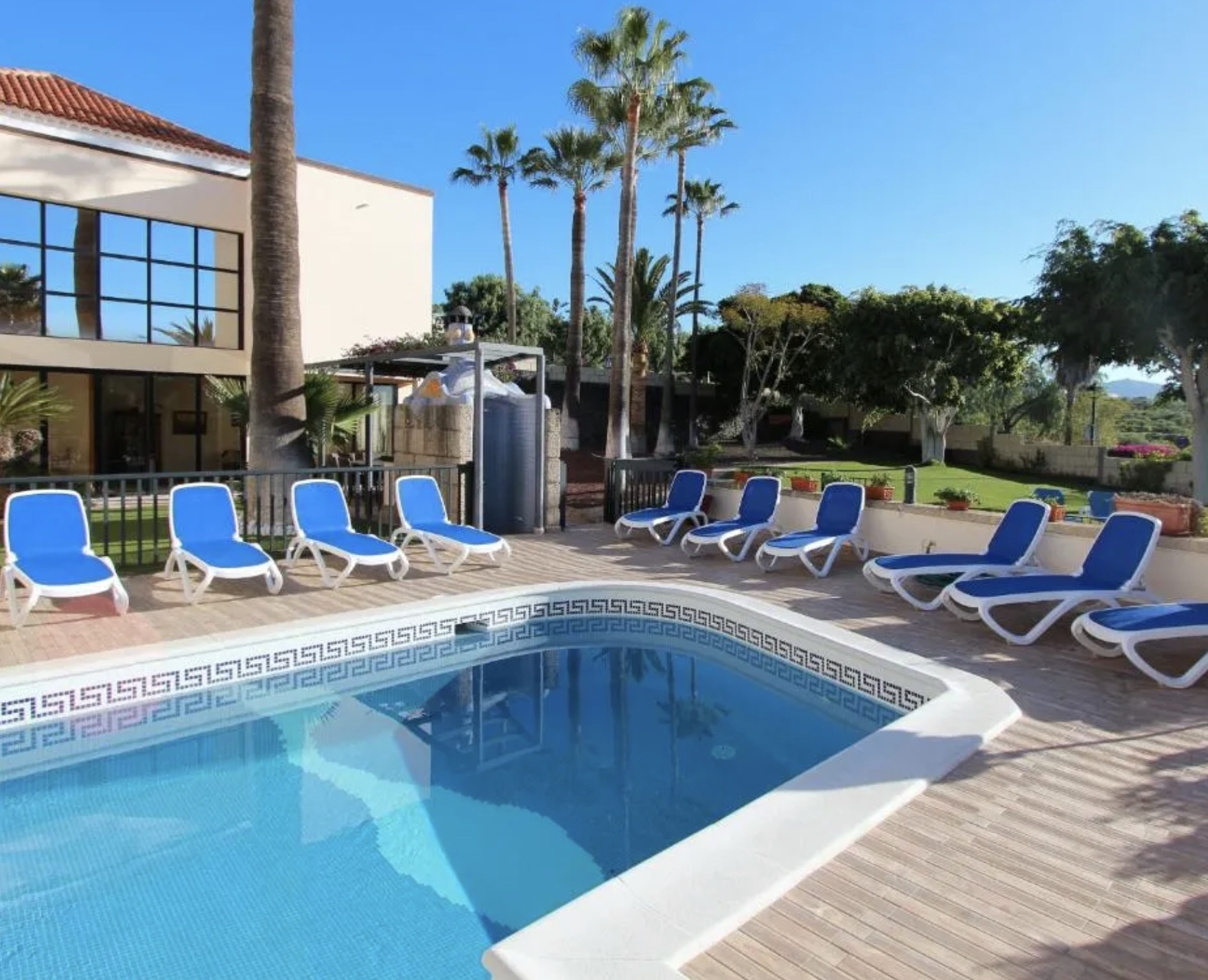 Women practicing yoga at sunset overlooking the ocean